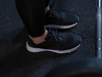 Athletic shoes and gym gear on floor